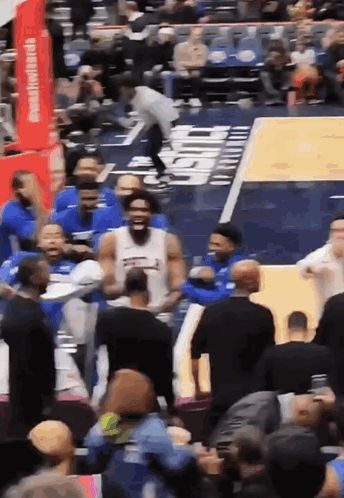 A Basketball Game Is Being Played In Front Of A Crowd With A Sign That Says Chase On It GIF