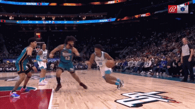 A Basketball Game Is Being Played In Front Of A Crowd With A Sign That Says Fire On It GIF