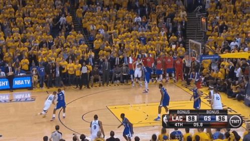 a basketball game is being played in front of a crowd with a tnt advertisement