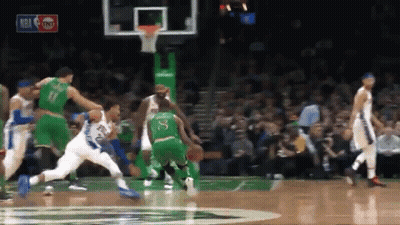 A Basketball Game Is Being Played In Front Of A Crowd With A Tnt Logo In The Background GIF