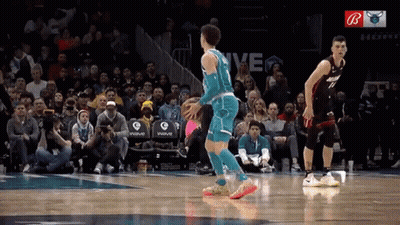 A Basketball Game Is Being Played In Front Of A Crowd With The Word Wave On The Stands GIF