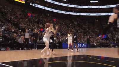 A Basketball Game Is Being Played In Front Of A Delta Advertisement GIF