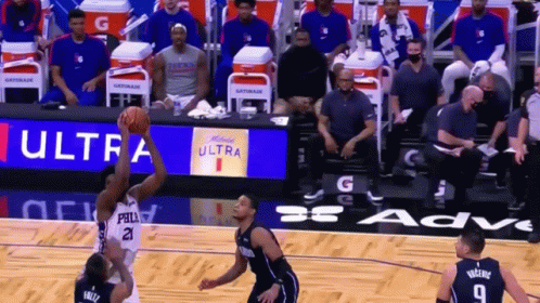 A Basketball Game Is Being Played In Front Of A Gatorade Banner GIF