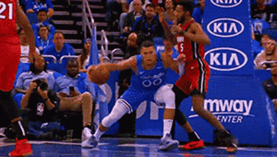 A Basketball Game Is Being Played In Front Of A Kia Advertisement . GIF