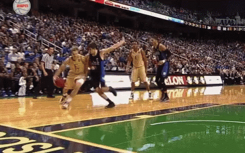 A Basketball Game Is Being Played In Front Of A Large Crowd And A Sign That Says Espn On It GIF