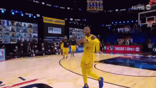 A Basketball Game Is Being Played In Front Of A Large Screen That Says Team Lebron GIF