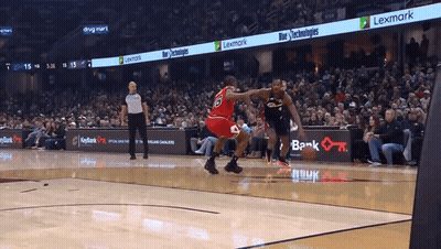 A Basketball Game Is Being Played In Front Of A Lexmark Advertisement GIF