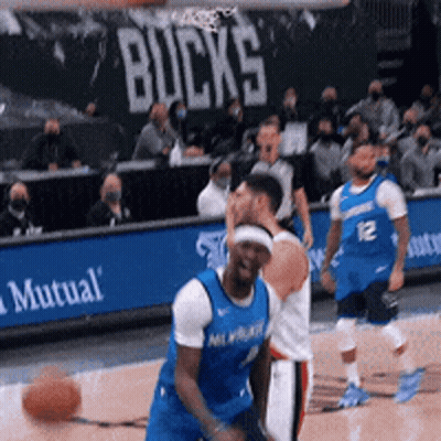 A Basketball Game Is Being Played In Front Of A Mutual Banner GIF