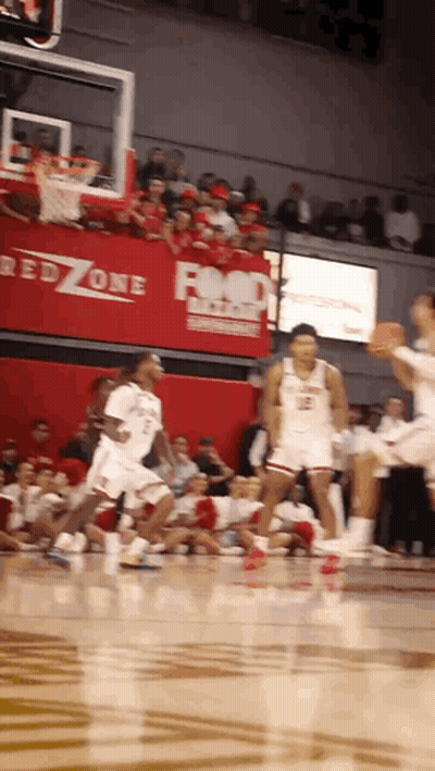A Basketball Game Is Being Played In Front Of A Red Zone Advertisement GIF