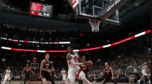 A Basketball Game Is Being Played In Front Of A Scoreboard Sponsored By Uber GIF