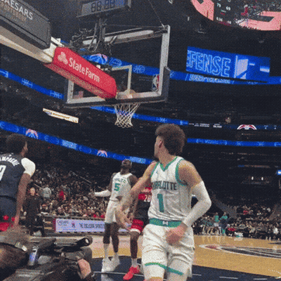 A Basketball Game Is Being Played In Front Of A Scoreboard That Says State Farm GIF
