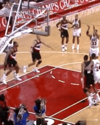 A Basketball Game Is Being Played In Front Of A Sign That Says Champions GIF