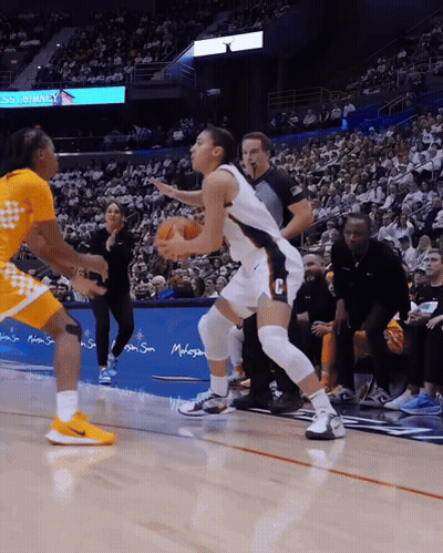 A Basketball Game Is Being Played In Front Of A Sign That Says ' Disney ' On It GIF