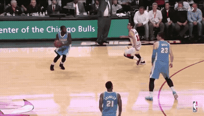 A Basketball Game Is Being Played In Front Of A Sign That Says " Enter Of The Chicago Bulls " GIF