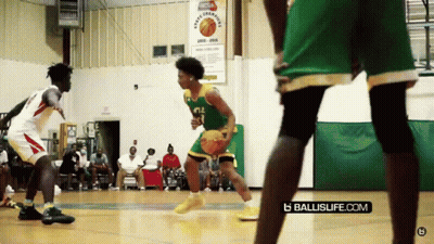 A Basketball Game Is Being Played In Front Of A Sign That Says Sports League GIF