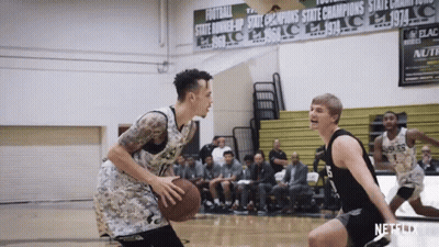 A Basketball Game Is Being Played In Front Of A Sign That Says ' State Champions ' GIF