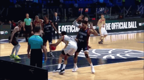 A Basketball Game Is Being Played In Front Of A Sign That Says " The Official Ball " GIF