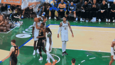 A Basketball Game Is Being Played In Front Of A Statefarm Banner GIF