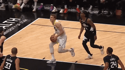 A Basketball Game Is Being Played In Front Of A University Of Utah Banner GIF