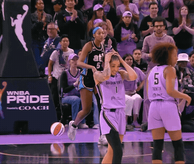 A Basketball Game Is Being Played In Front Of A Wnba Pride Sign GIF