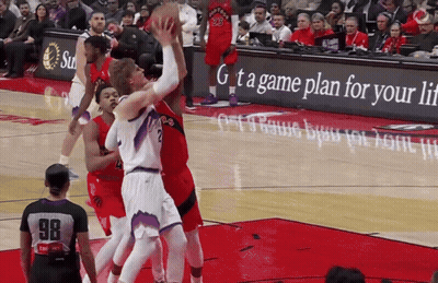 A Basketball Game Is Being Played In Front Of An Advertisement For A Game Plan For Your Life GIF