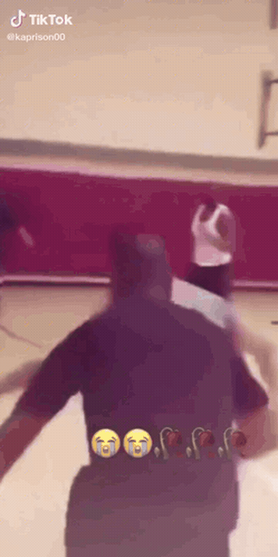 A Basketball Game Is Being Played On A Court And A Man Is Crying . GIF