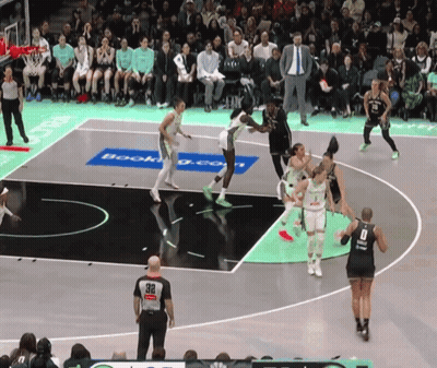 A Basketball Game Is Being Played On A Court That Has A Booking.com Advertisement On It GIF