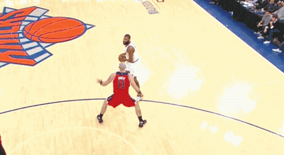 a basketball game is being played on a court that has a hoop on it