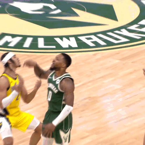 A Basketball Game Is Being Played On A Court That Says Milwaukee On It GIF