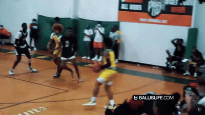 A Basketball Game Is Being Played On A Court With A Banner That Says Ballislife.com . GIF