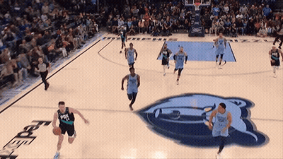 A Basketball Game Is Being Played On A Court With A Bear Logo In The Background GIF