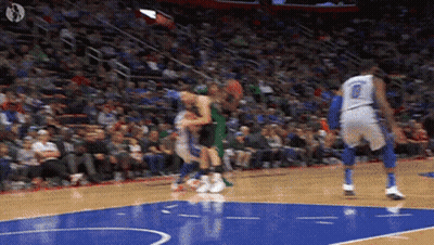 A Basketball Game Is Being Played On A Court With A Crowd In The Stands . GIF