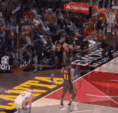 A Basketball Game Is Being Played On A Court With A Crowd In The Stands . GIF