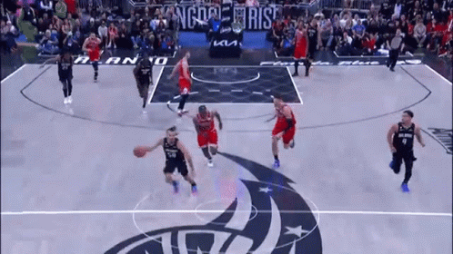 A Basketball Game Is Being Played On A Court With A Logo That Says Kings On It . GIF