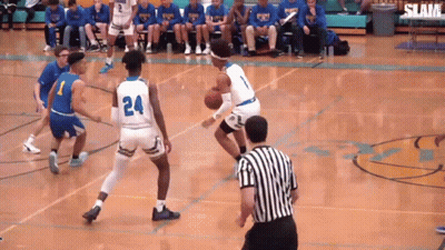 A Basketball Game Is Being Played On A Court With A Referee GIF