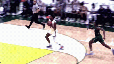 A Basketball Game Is Being Played On A Court With A Referee Watching GIF