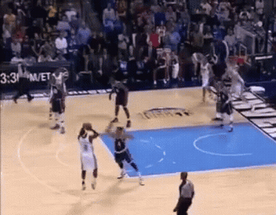 A Basketball Game Is Being Played On A Court With A Referee . GIF