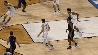 A Basketball Game Is Being Played On A Court With A Referee GIF