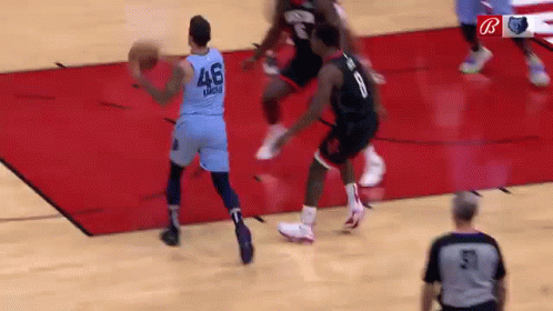 A Basketball Game Is Being Played On A Court With A Referee . GIF