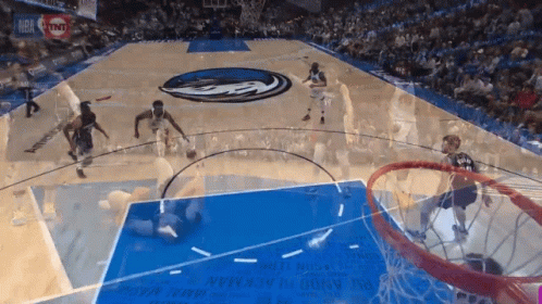A Basketball Game Is Being Played On A Court With A Tnt Ad GIF