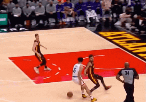 A Basketball Game Is Being Played On A Court With An Atlanta Advertisement In The Background GIF