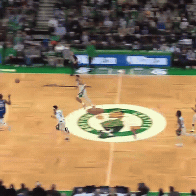 A Basketball Game Is Being Played On A Court With The Celtics Logo In The Middle GIF