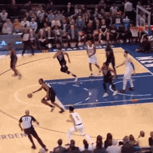 A Basketball Game Is Being Played On A Court With The Number 77 On The Back Of A Player GIF
