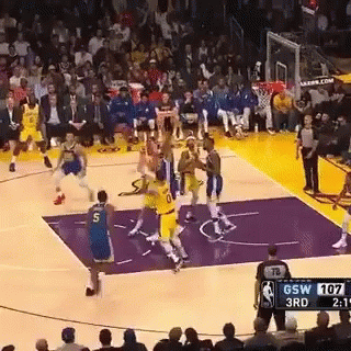 A Basketball Game Is Being Played On A Purple Court . GIF