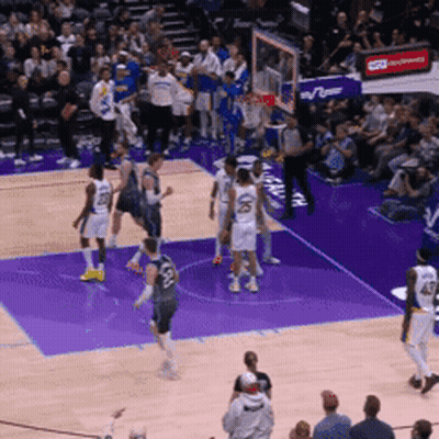 A Basketball Game Is Being Played On A Purple Court With A Crowd In The Stands GIF