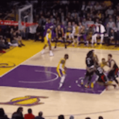 A Basketball Game Is Being Played On A Purple Court With A Crowd Watching . GIF