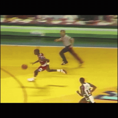 A Basketball Game Is Being Played With A Referee Watching GIF