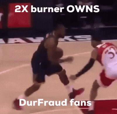 A Basketball Player Dribbles The Ball While Another Player Tries To Stop Him GIF