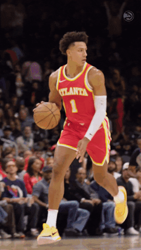A Basketball Player For The Atlanta Team Is Dribbling The Ball GIF