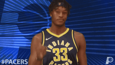 A Basketball Player For The Indiana Pacers Points Upwards GIF